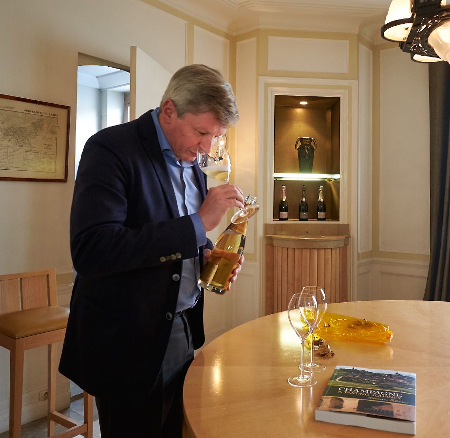 Jean Baptiste Lecaillon at Roederer, has a look at the 2002 Cristal he opened to share with Kaaren Palmer after her book launch : Photo © Milton Wordley.
