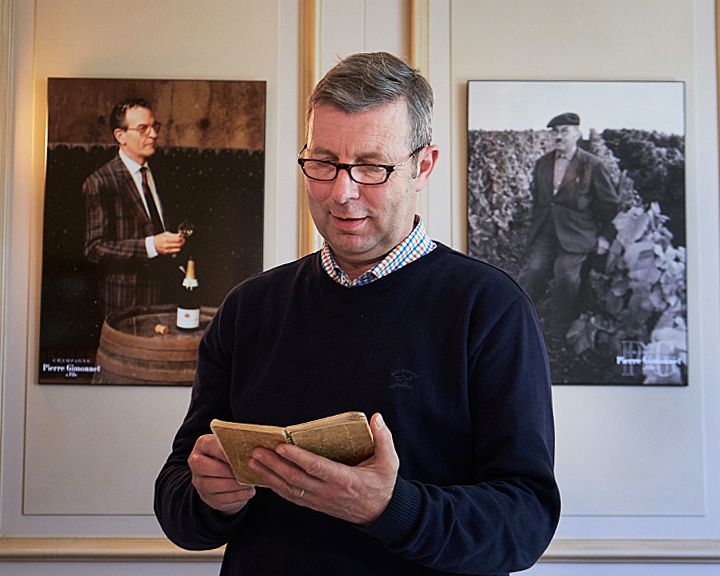 Didier Gimmonet with his father's notebook, in front of portraits of his father and grandfather : Photo © Milton Wordley.