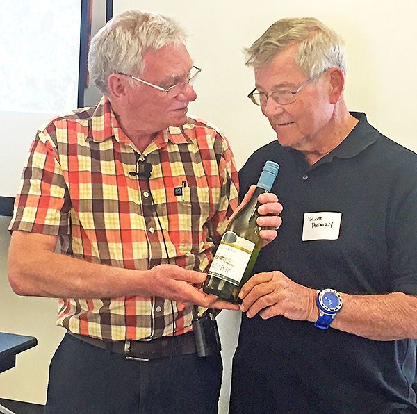 Dr Richard presents Scott Henry with a bottle of NZ  Oyster Bay Sauvignon Blanc.