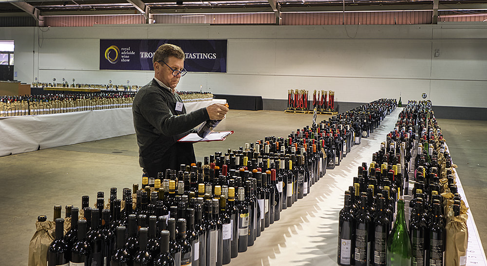 Andrew Hardy past Wine Committee Chair of South Australia's Royal Agricultural and Horticultural Society, checks the entries in the back hall before they go out to be judges.